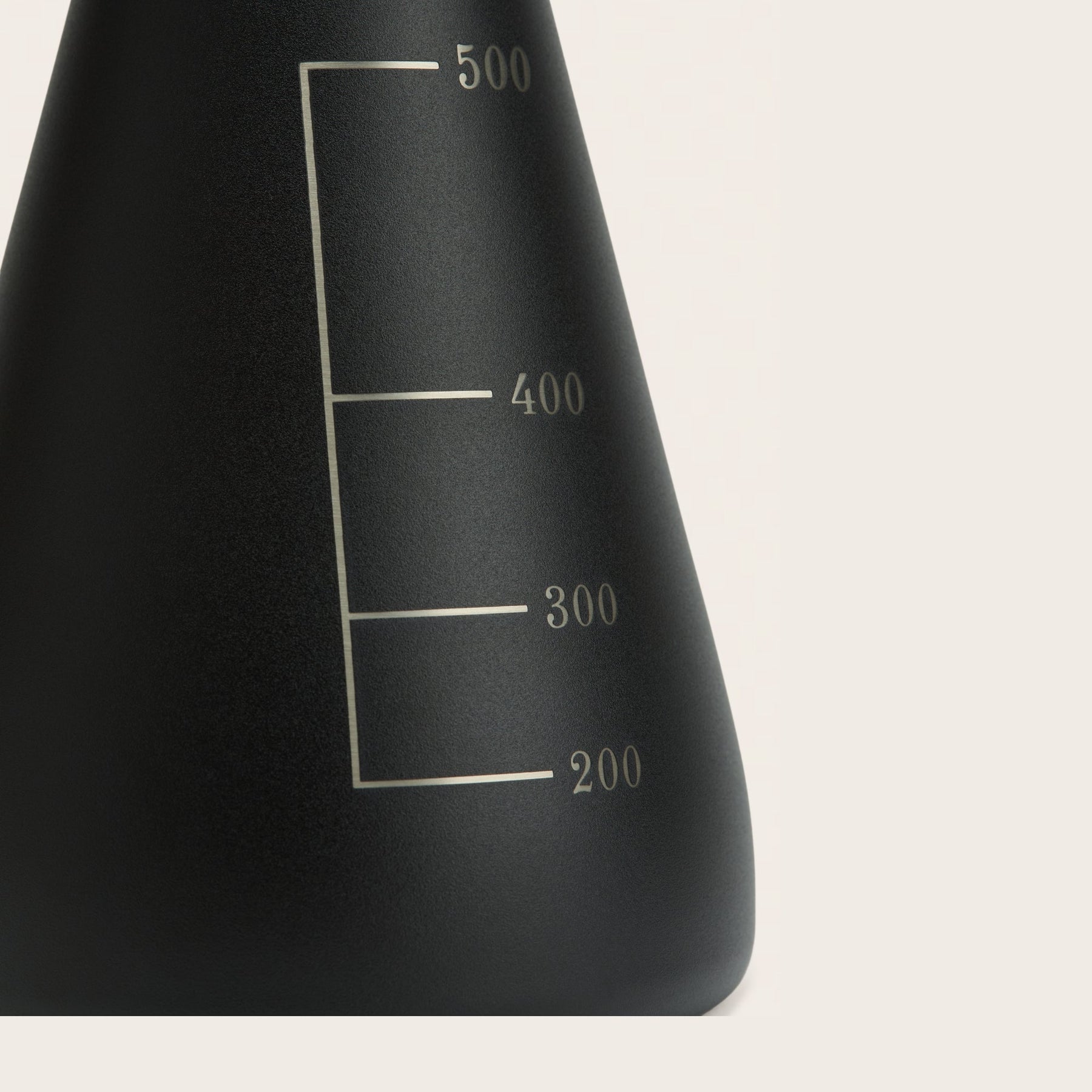 Permanent laser-engraved detail on a Carbon Black Flask Vessel, a premium alternative to disposable promotional drinkware