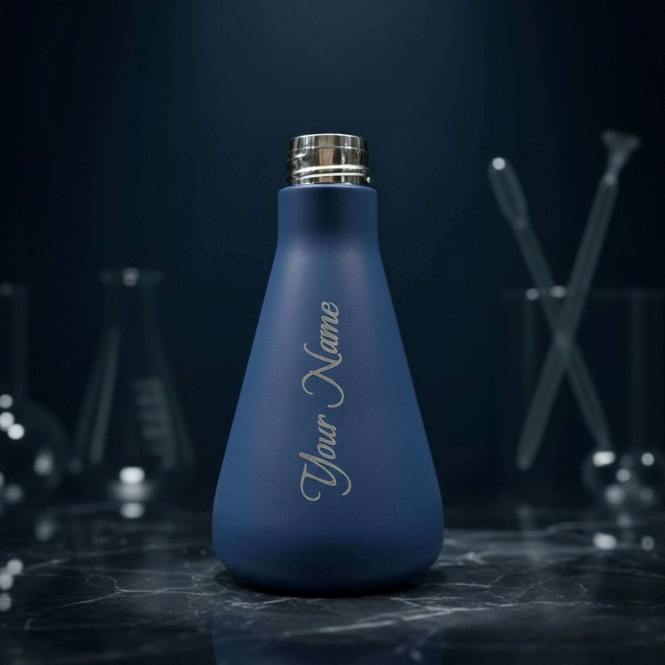 Blue bottle with 'Your Name' engraving on a dark background