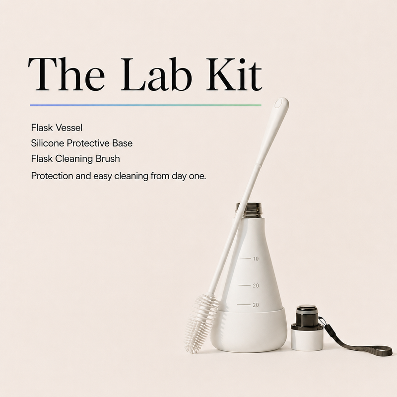 Title card reading The Lab Kit, listing Flask Vessel, Silicone Protective Base and Flask Cleaning Brush, beside a white flask-shaped bottle with a long cleaning brush and a separate lid and carry strap.