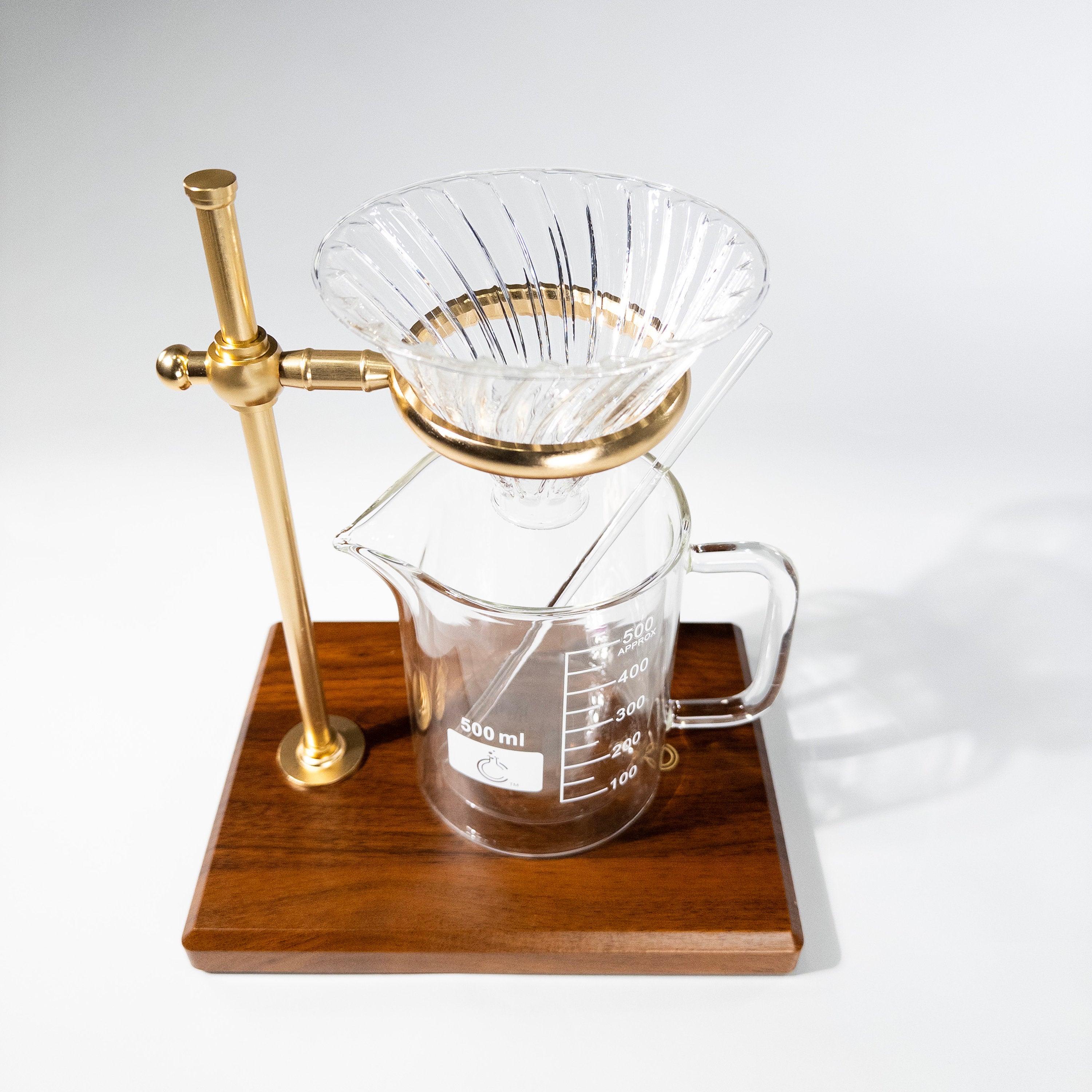 Pour-over coffee maker set makes a perfect STEM graduation or birthday gift for science enthusiasts. The set comes with a wood and gold ring stand, a glass funnel, a double wall insulated beaker mug, glass stir rod and a pack of paper coffee filters